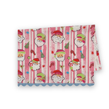 Folded Jolly Santas Christmas cotton tea towel featuring playful Santa faces, festive holiday motifs, pink stripes, and blue scalloped trim.