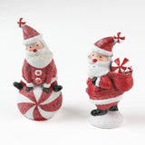 Two Santa Claus table decorations on a white background