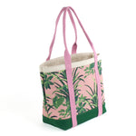 a large Jungle Road canvas tote bags with a pink and green leaf pattern, displayed against a white background.
