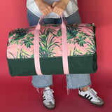 Jungle Road pink and green canvas duffle bag with model 