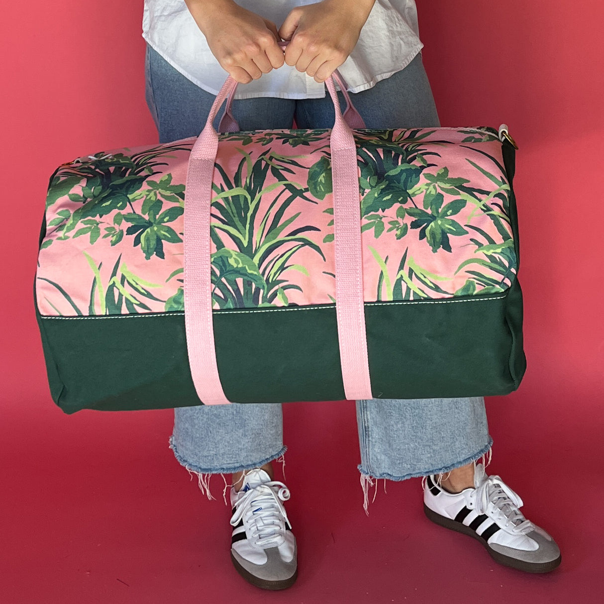Jungle Road pink and green canvas duffle bag with model 