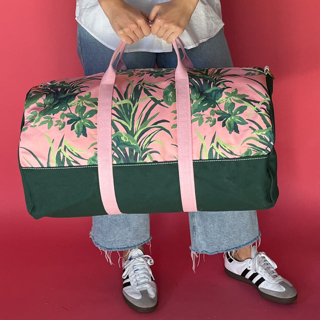 Jungle Road pink and green canvas duffle bag with model 