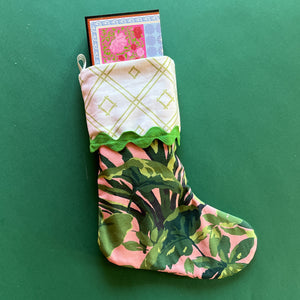 A palm leaf print pink and green Christmas stocking.