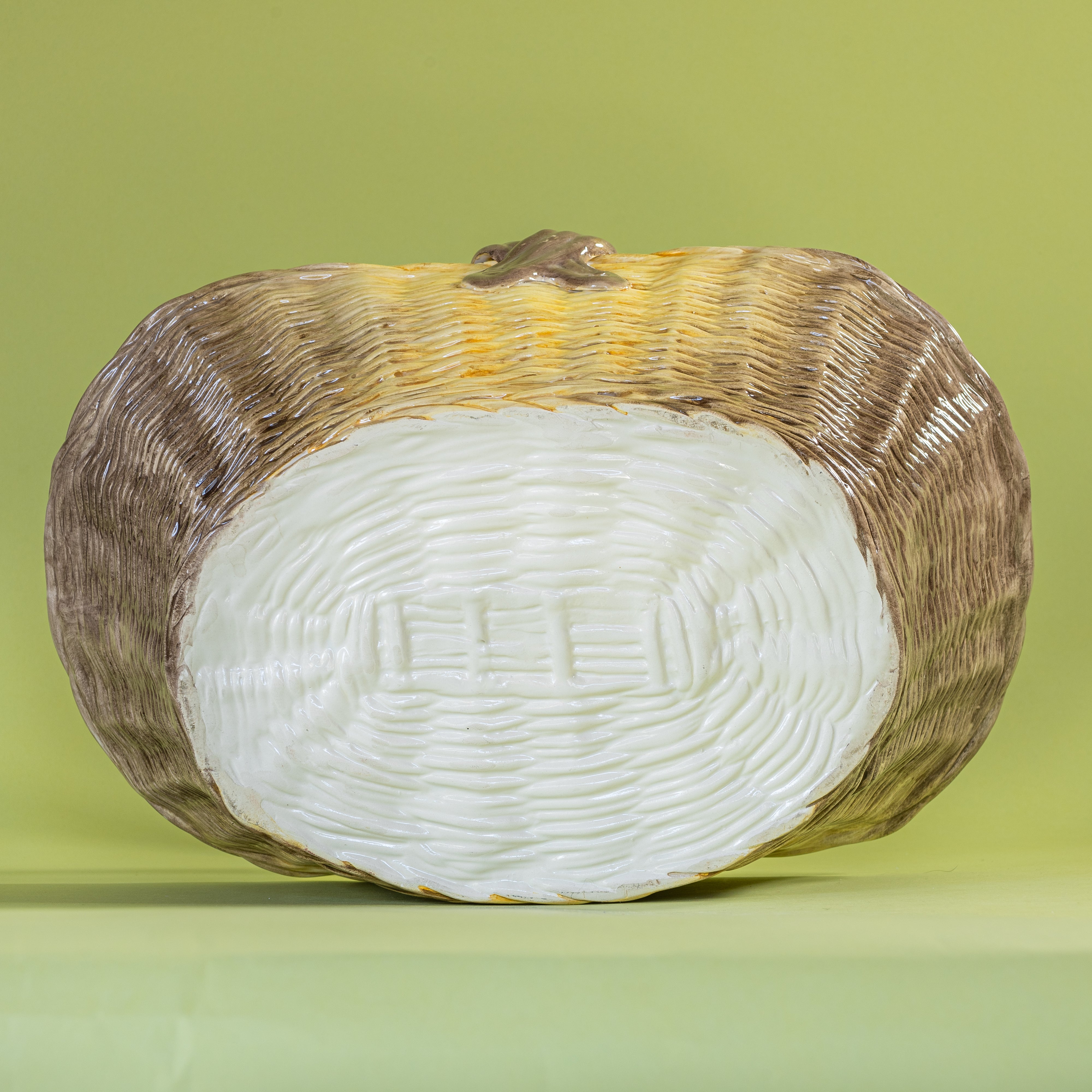 Large brown ceramic basket with woven texture and curved handle