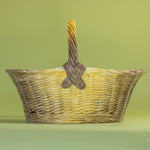 Large brown ceramic basket with woven texture and curved handle