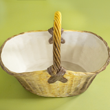 Large brown ceramic basket with woven texture and curved handle