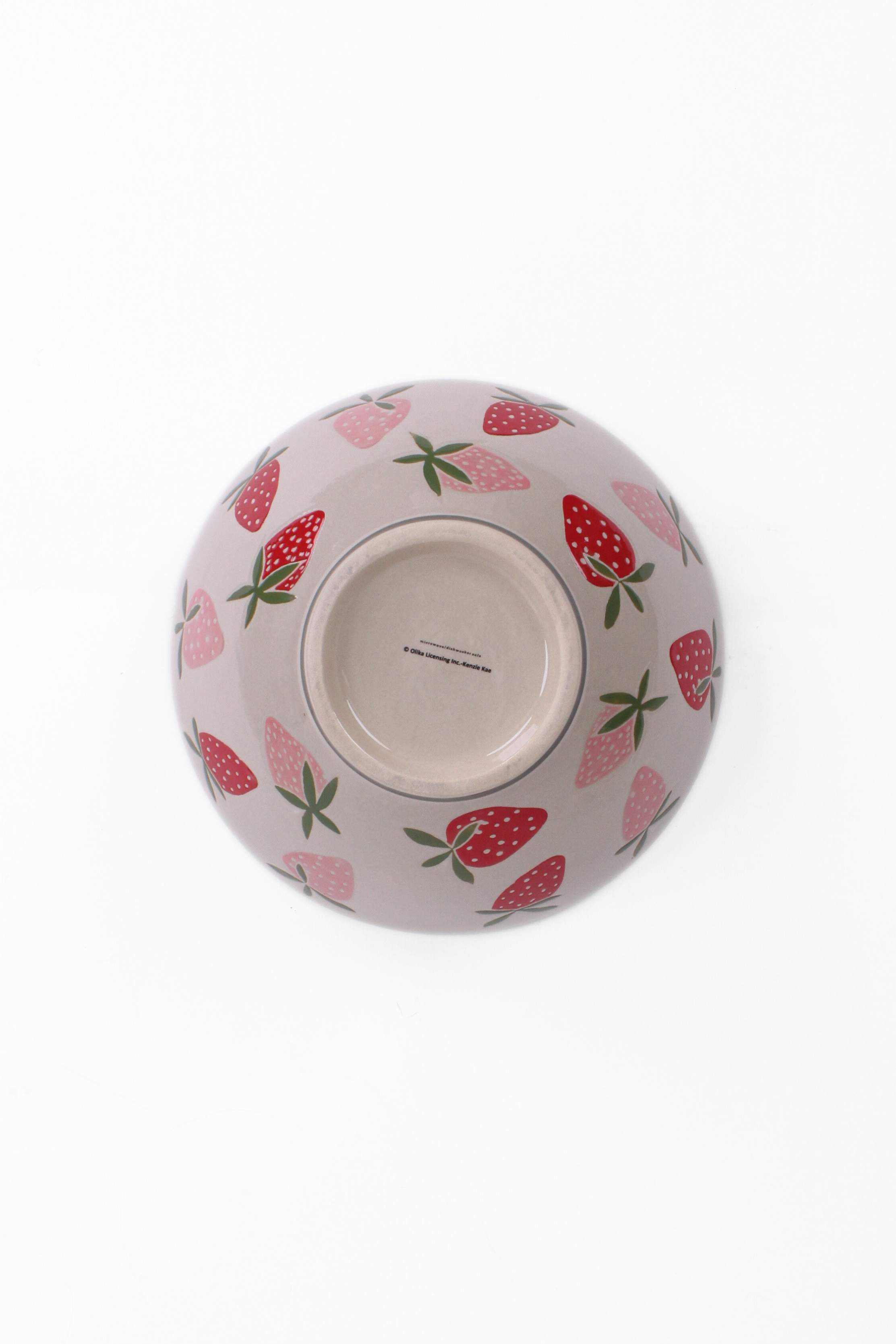 Large ceramic serving bowl with pink strawberry pattern, shown holding green pears bottom