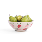 Large ceramic serving bowl with pink strawberry pattern, shown holding green pears