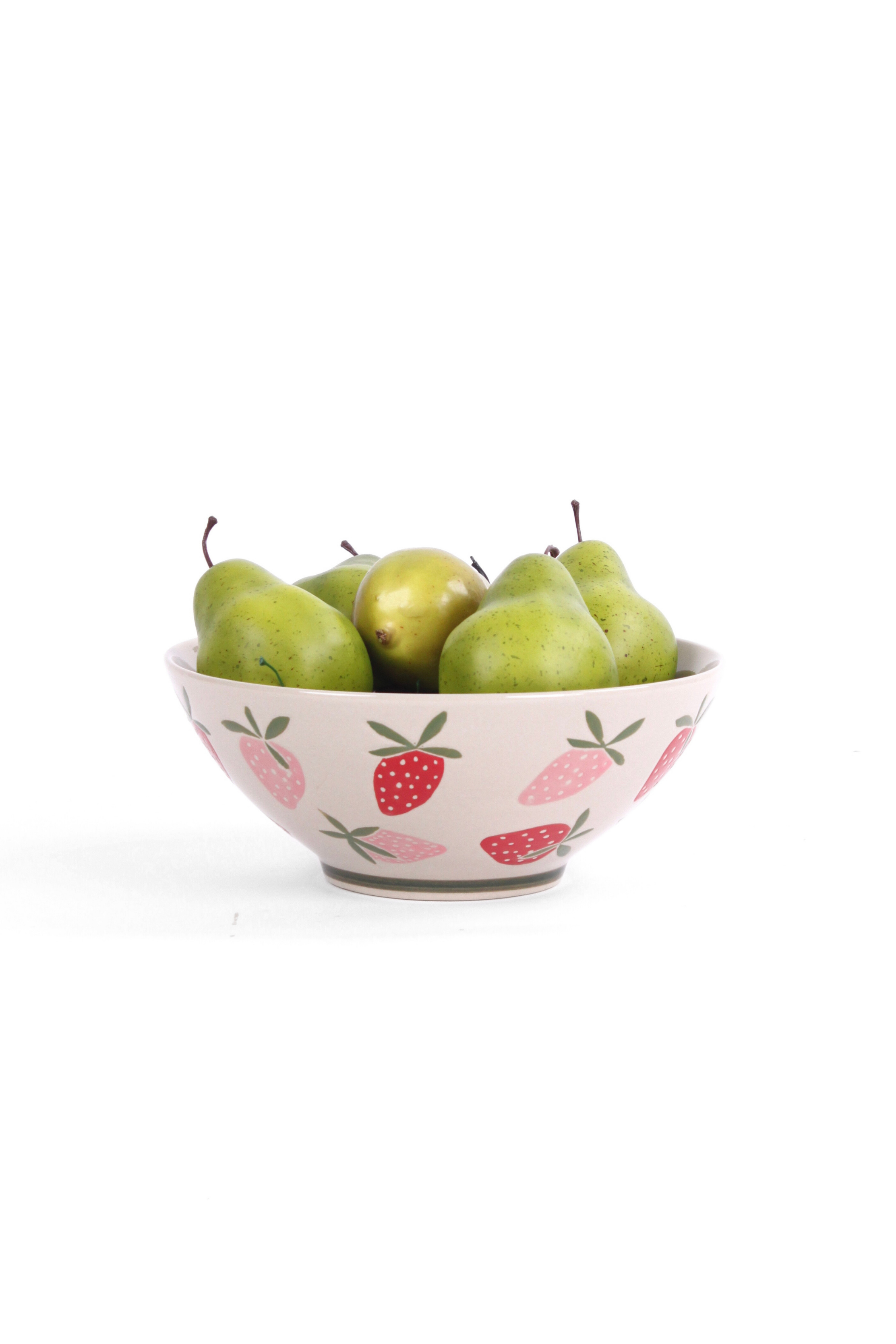 Large ceramic serving bowl with pink strawberry pattern, shown holding green pears