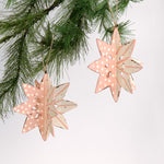 Set of two large wooden star christmas ornaments painted in pink and white with distressed polka dot details