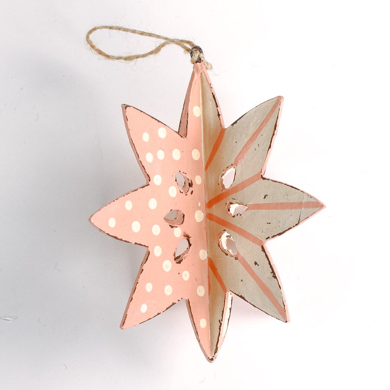 a large wooden star christmas ornaments painted in pink and white with distressed polka dot details