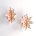 Set of two large wooden star christmas ornaments painted in pink and white with distressed polka dot details