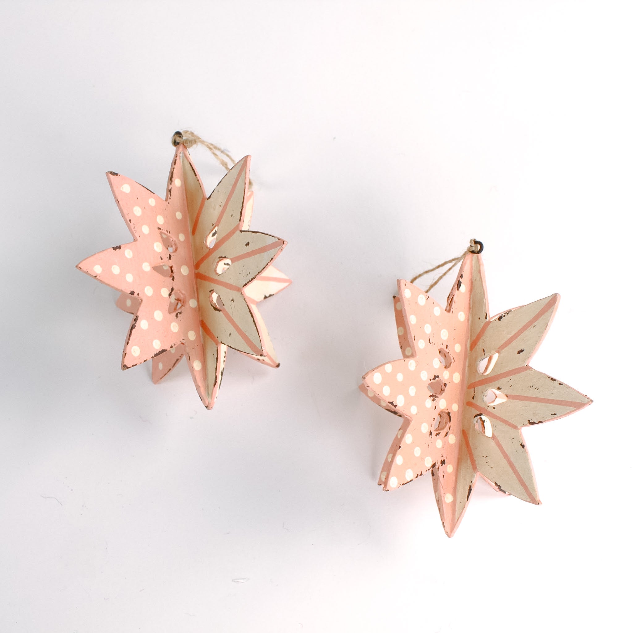 Set of two large wooden star christmas ornaments painted in pink and white with distressed polka dot details