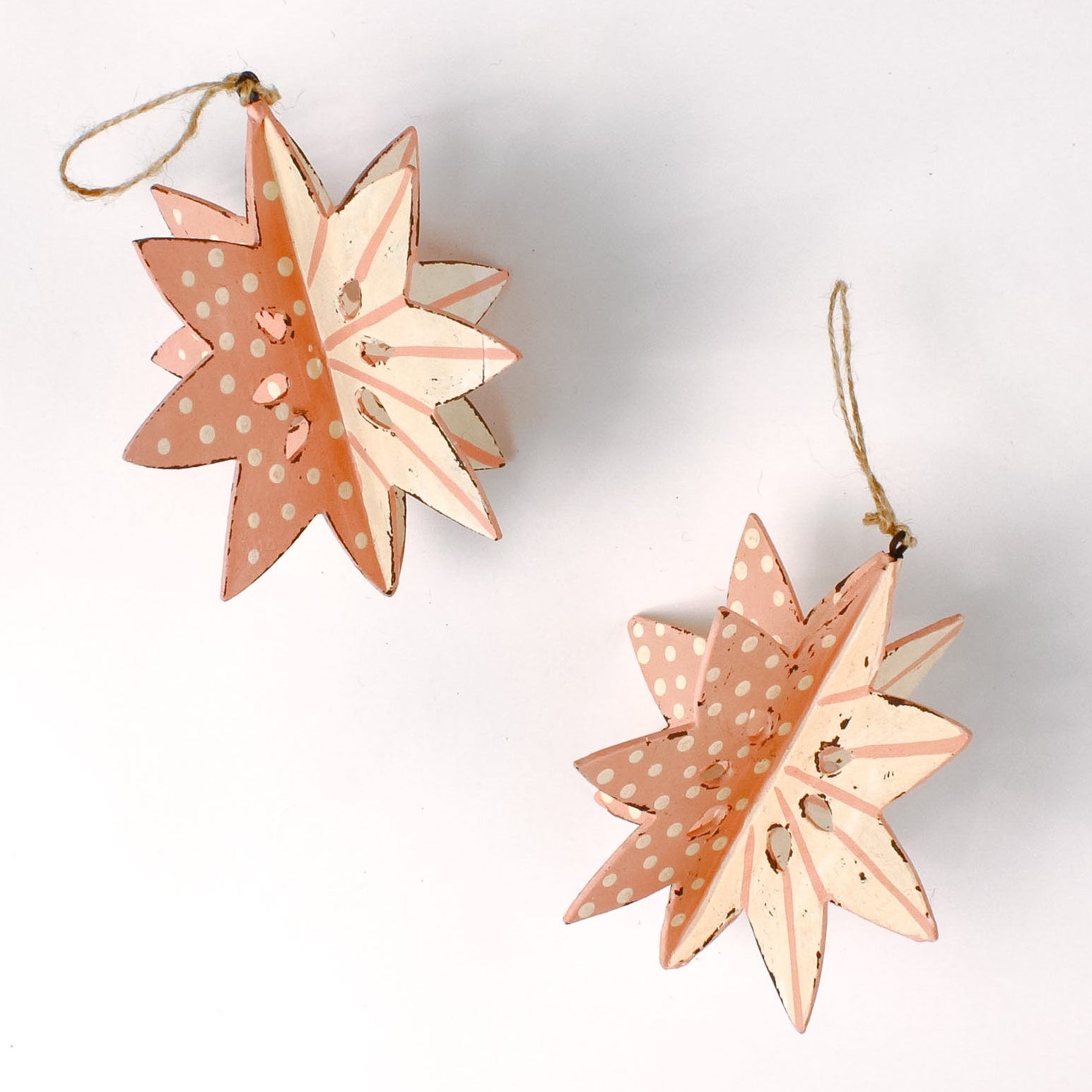 set of two large wooden star christmas ornaments painted in pink and white with distressed polka dot details