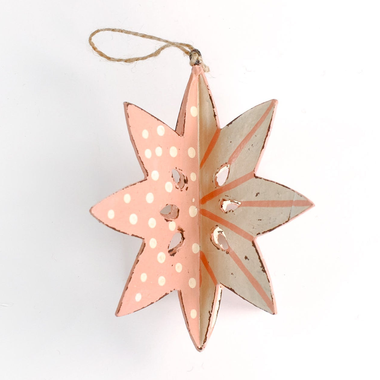 a large wooden star christmas ornaments painted in pink and white with distressed polka dot details