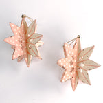 Set of two large wooden star christmas ornaments painted in pink and white with distressed polka dot details