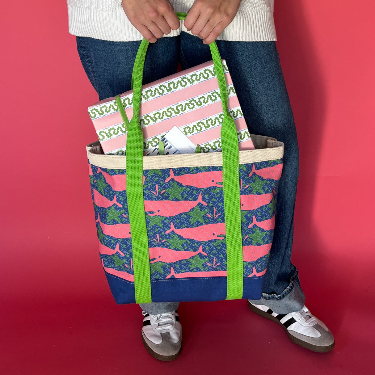 Canvas tote made from pink whale motif fabric and lime green straps. 