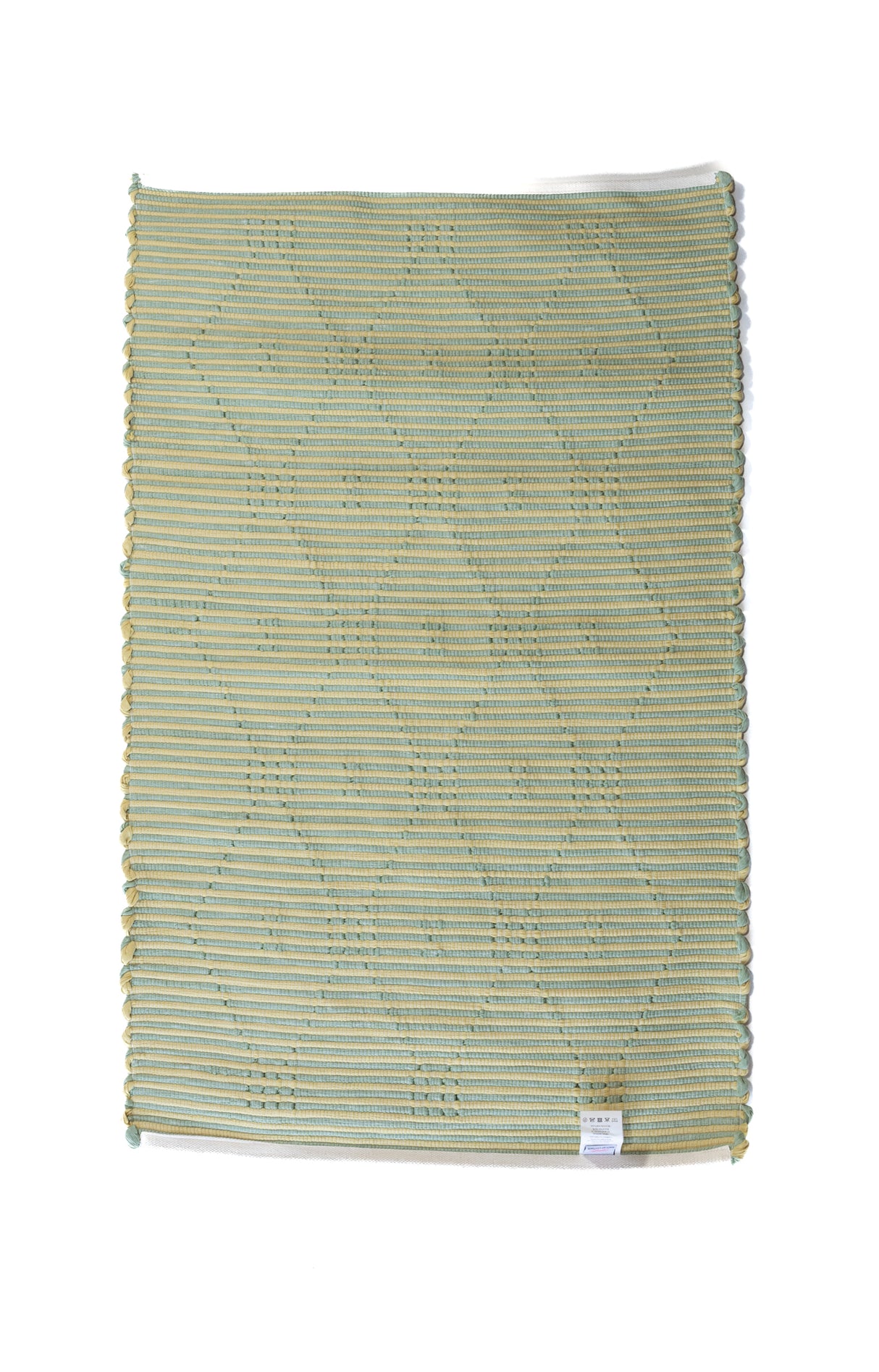 A madcap cottage yellow and green striped accent rug with a lattice motif across the front