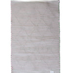 the plain reverse side of a pink and green accent rug from madcap cottage