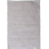 the plain reverse side of a pink and green accent rug from madcap cottage