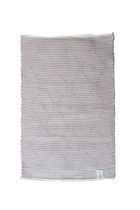 the plain reverse side of a pink and green accent rug from madcap cottage