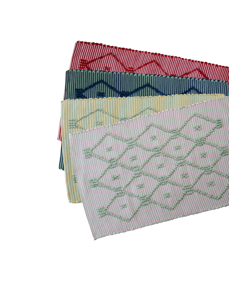 Four cotton accent rugs in red, navy, yellow and pink with a lattice motif from madcap cottage