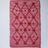 A madcap cottage white and red striped accent rug with a lattice motif across the front