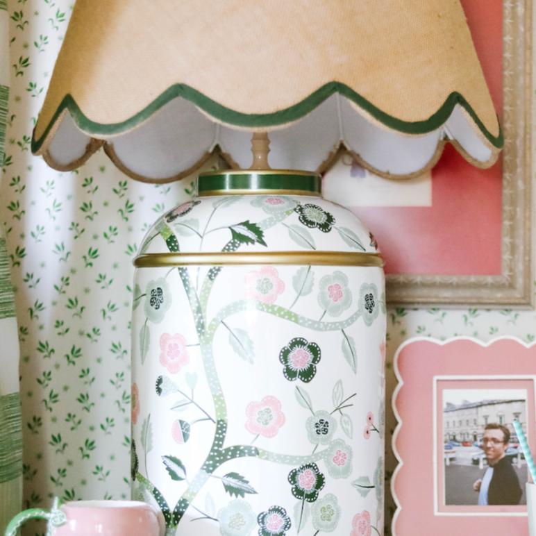 A tole metal madcap cottage chinoiserie lamp with a beige lampshade
