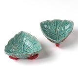 footed stoneware lobster bowls with a white background