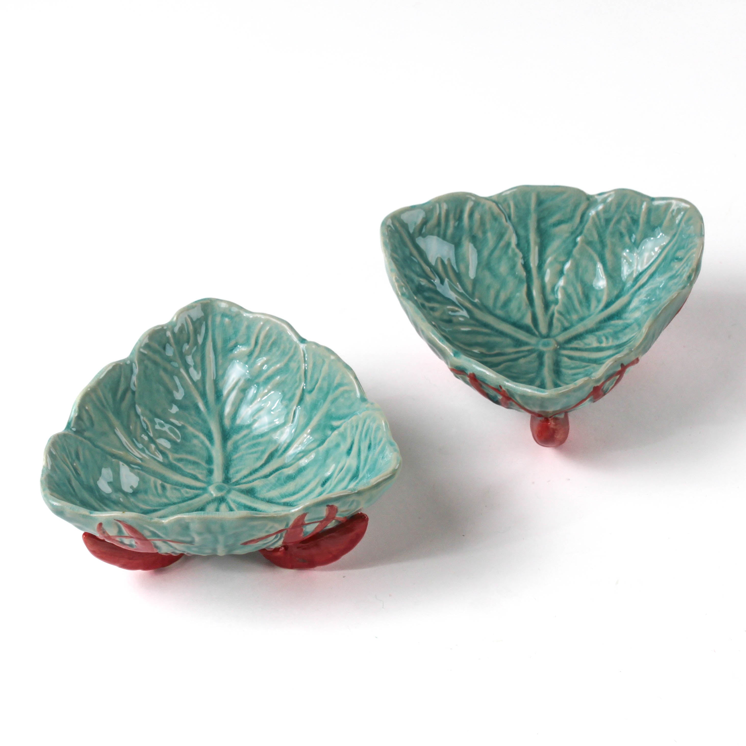 footed stoneware lobster bowls with a white background