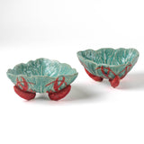 footed stoneware lobster bowls with a white background