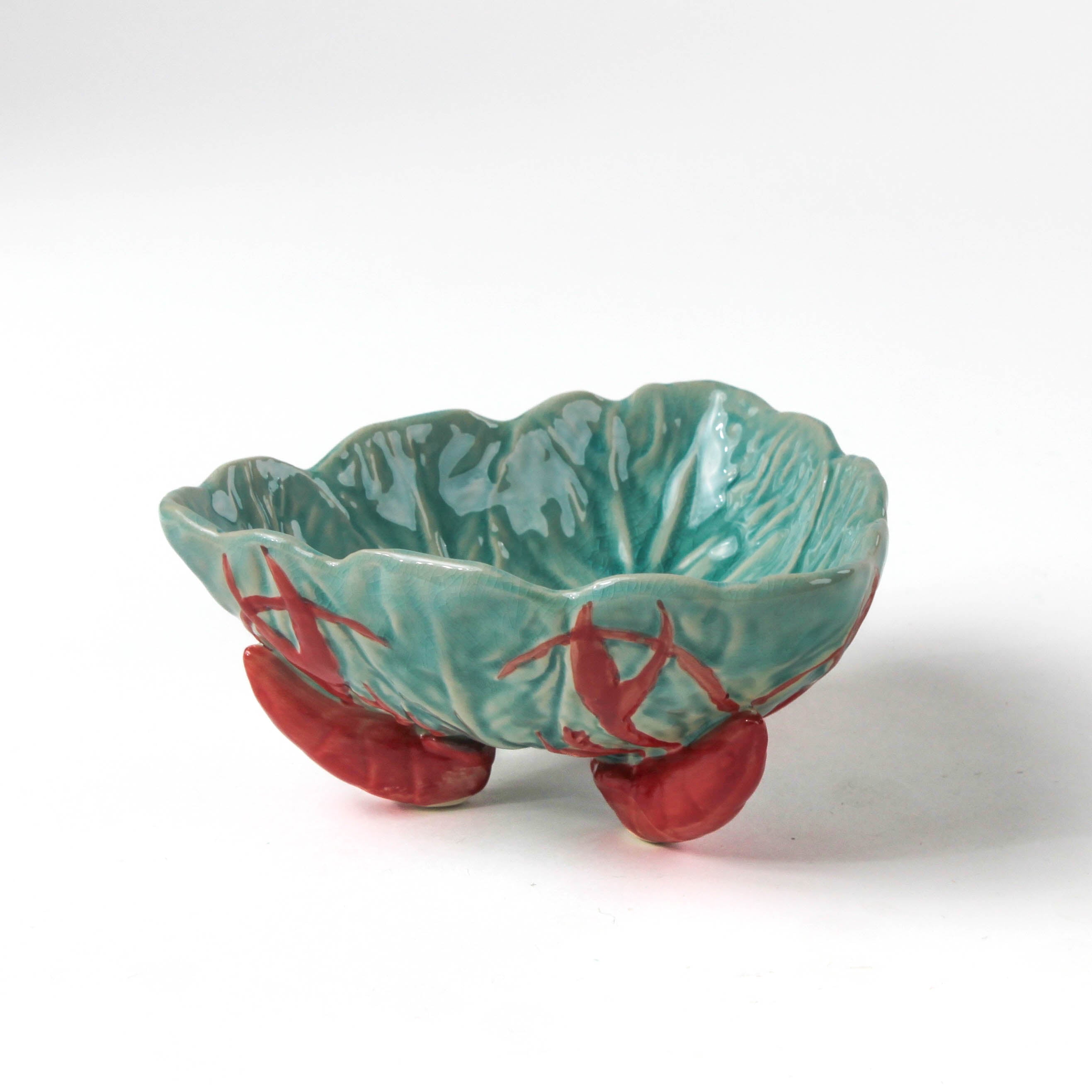 footed stoneware lobster bowls with a white background