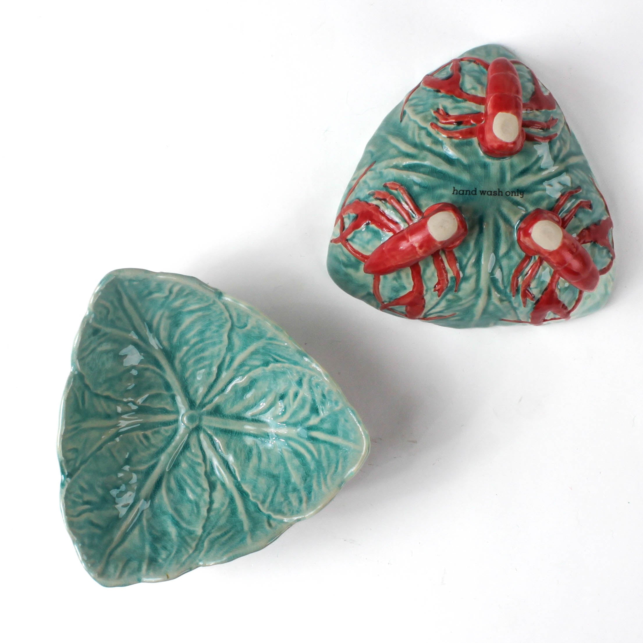 footed stoneware lobster bowls with a white background, 1 showing the bottom