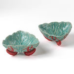 footed stoneware lobster bowls with a white background