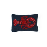 Navy blue pillow with a red lobster design on a white background