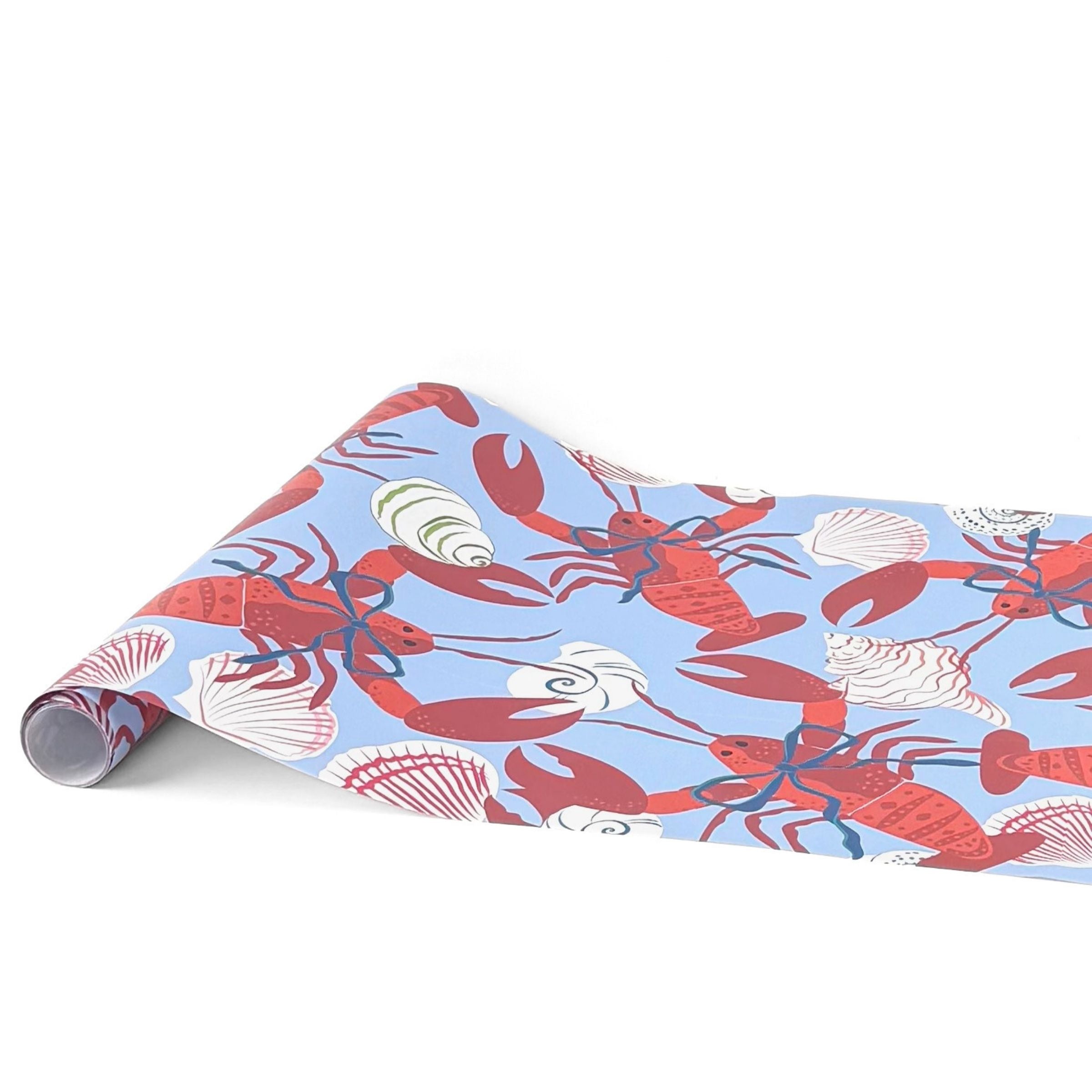 A blue coastal paper table runner with lobster and shell pattern on a white background