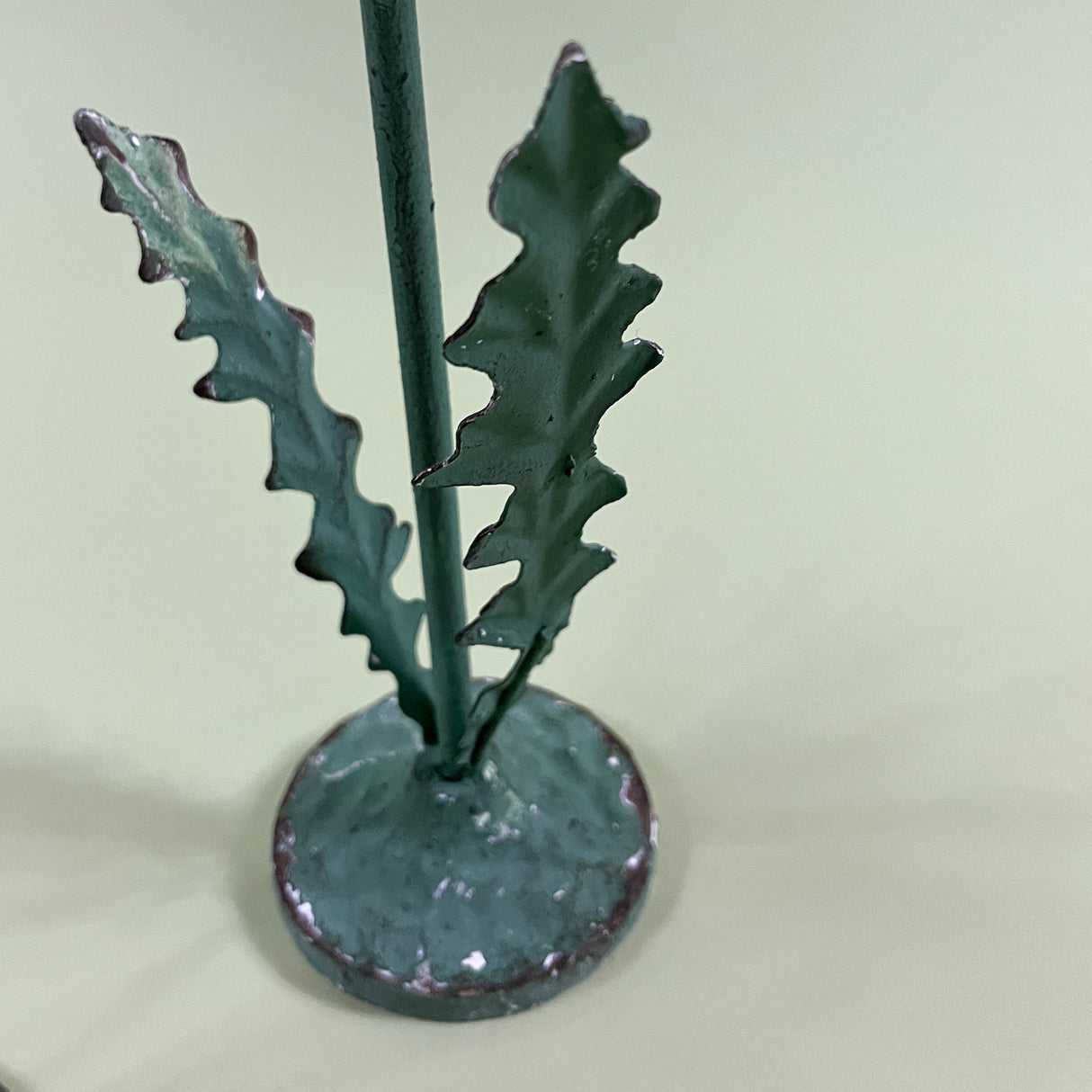 green stem detail of a metal lotus flower candle holder