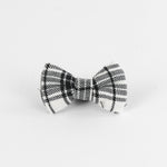 a MacLoecke Black/White Plaid Dog/Cat Bowties in Medium placed on a white surface