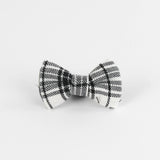 a MacLoecke Black/White Plaid Dog/Cat Bowties in Medium placed on a white surface