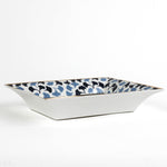 side view of a Madcap cottage blue and white porcelain trinket tray with the saying Children are wonderful but dogs don't have to go to college.