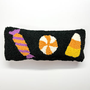 Madcap Cottage Black Halloween Throw pillow with three candy motifs colored orange, yellow, violet