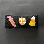 Madcap Cottage Black Halloween Throw pillow with three candy motifs