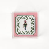 Nutcracker Square Acrylic Tray with in small size with pink and green border and Nutcracker in the center.