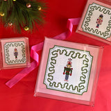 Nutcracker Square Acrylic Tray with in 3 sizes with pink and green border and Nutcracker in the center.