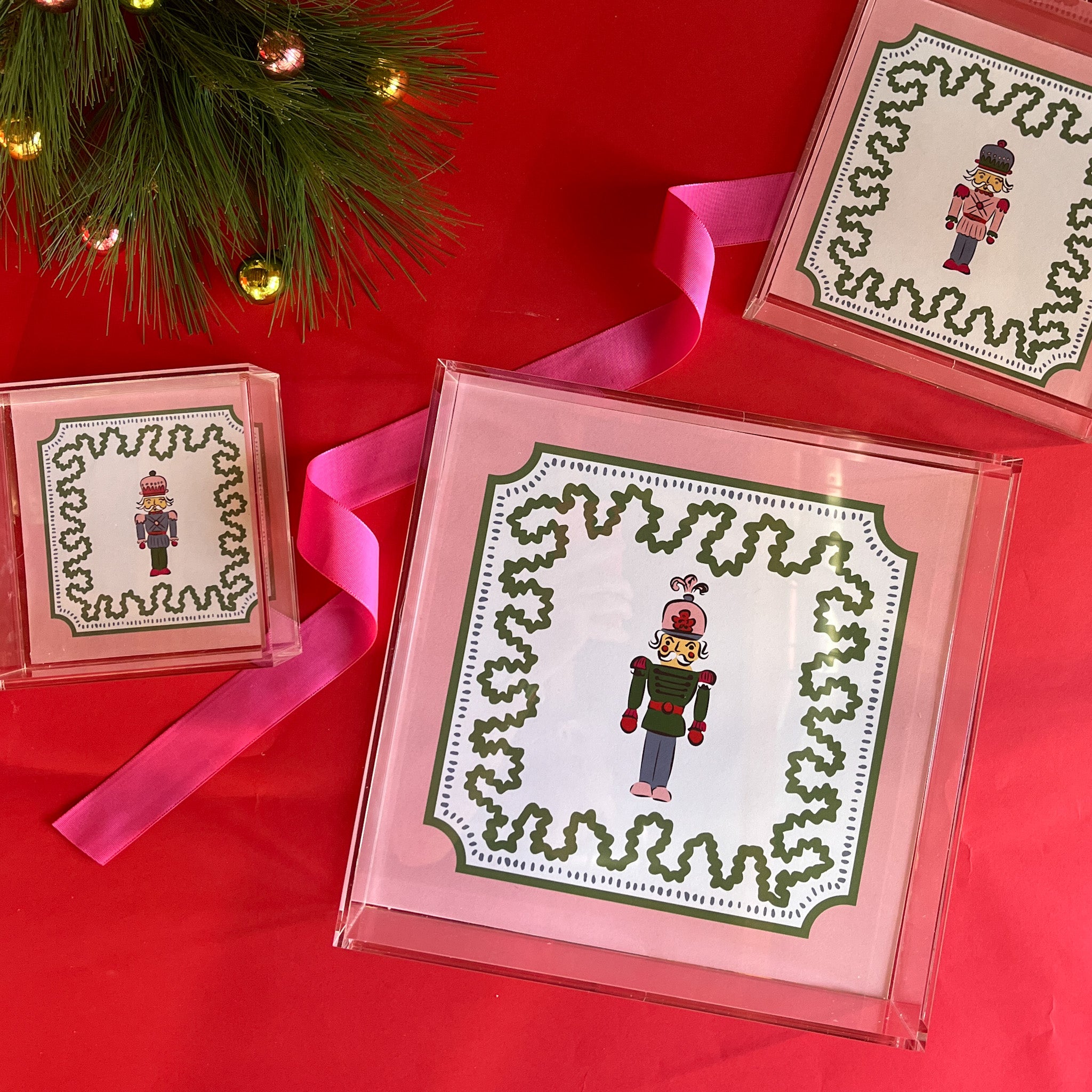 Nutcracker Square Acrylic Tray with in 3 sizes with pink and green border and Nutcracker in the center.
