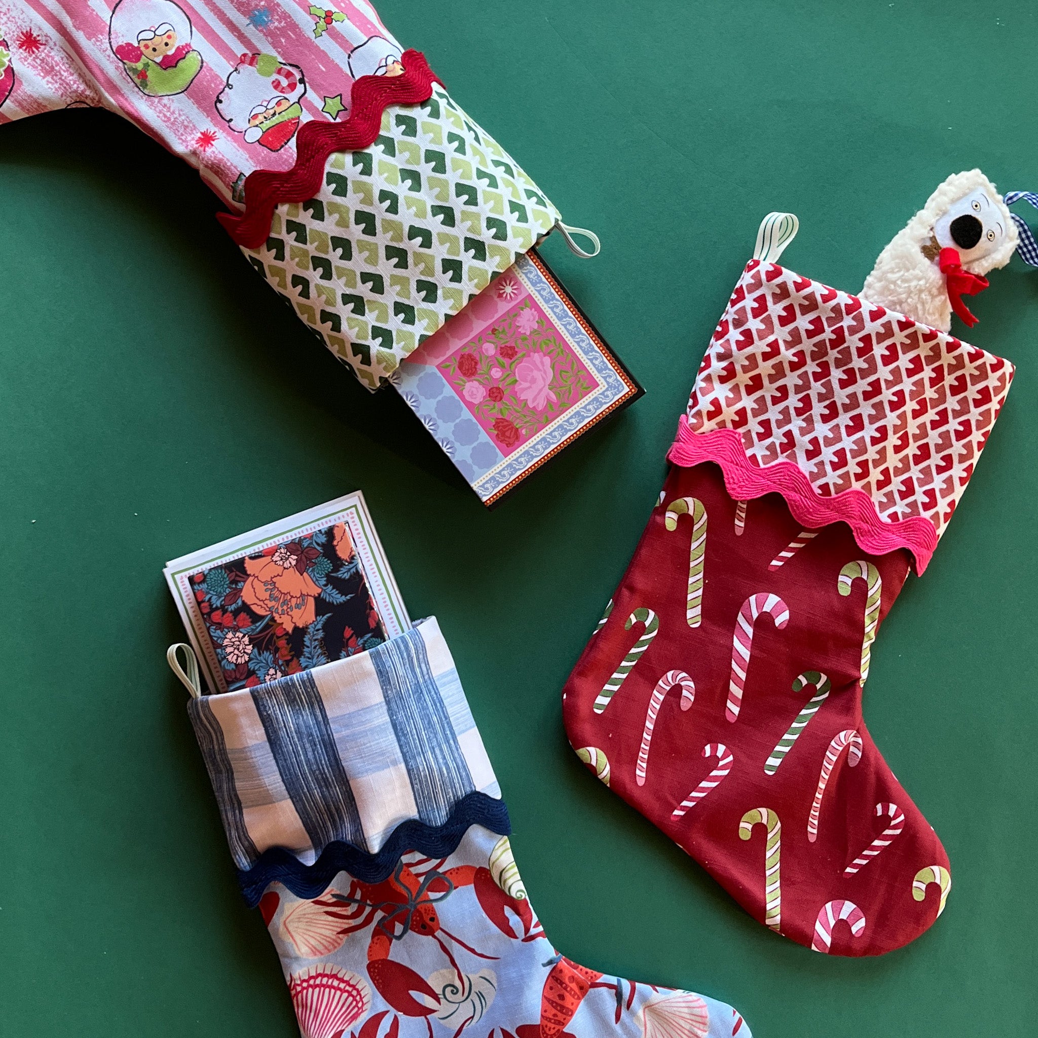 A trio of colorful Christmas stockings filled with small gifts.