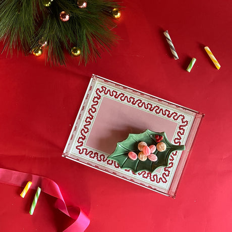 Harbor Trail red and pink with green dash Rectangular Acrylic Tray.  Large pink rectangle in the center with green dashes and red squiggle. A Christmas tree branch and candy are partially in the image.