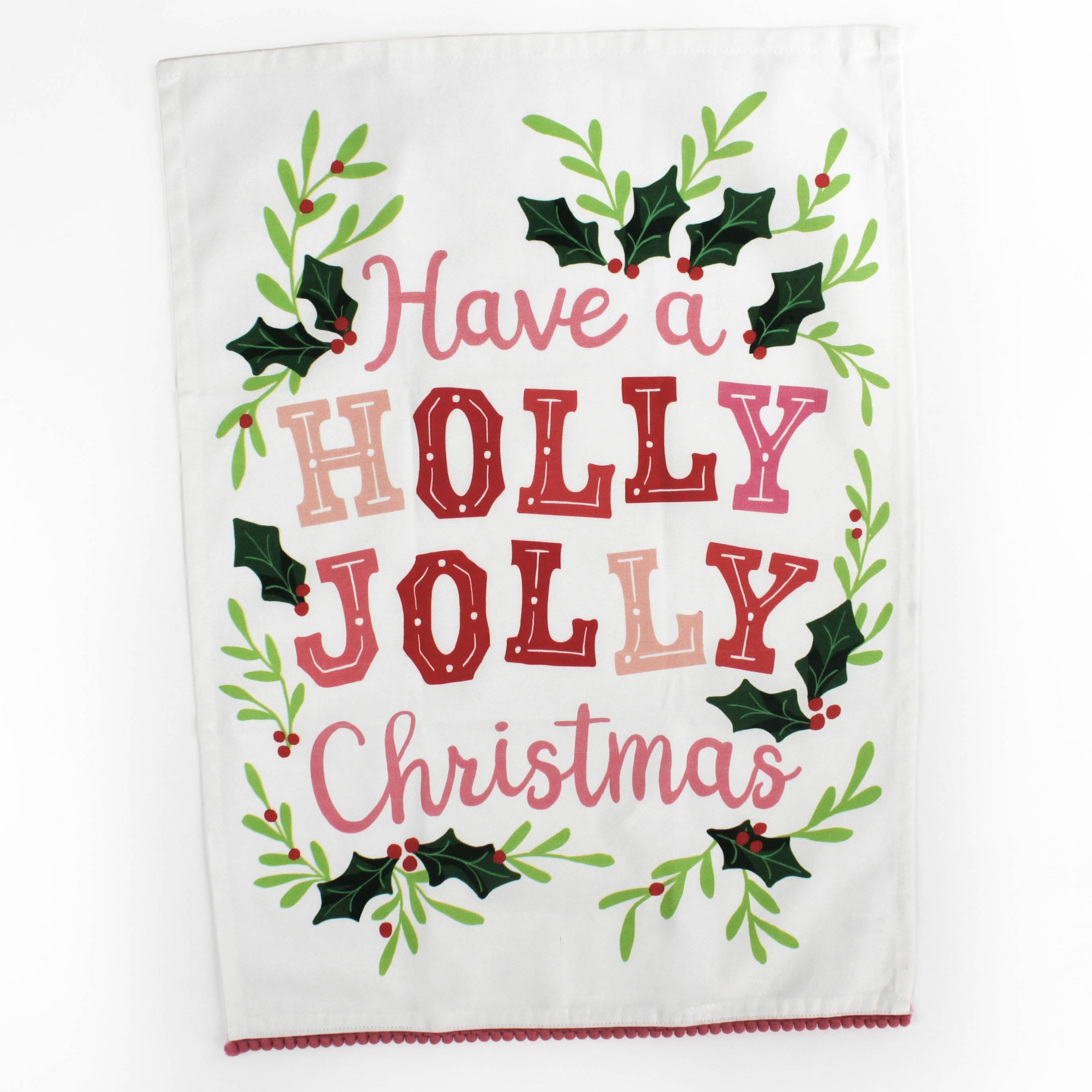 A Madcap Cottage Christmas tea towel with holly motifs and text that reads Have a Holly Jolly Christmas