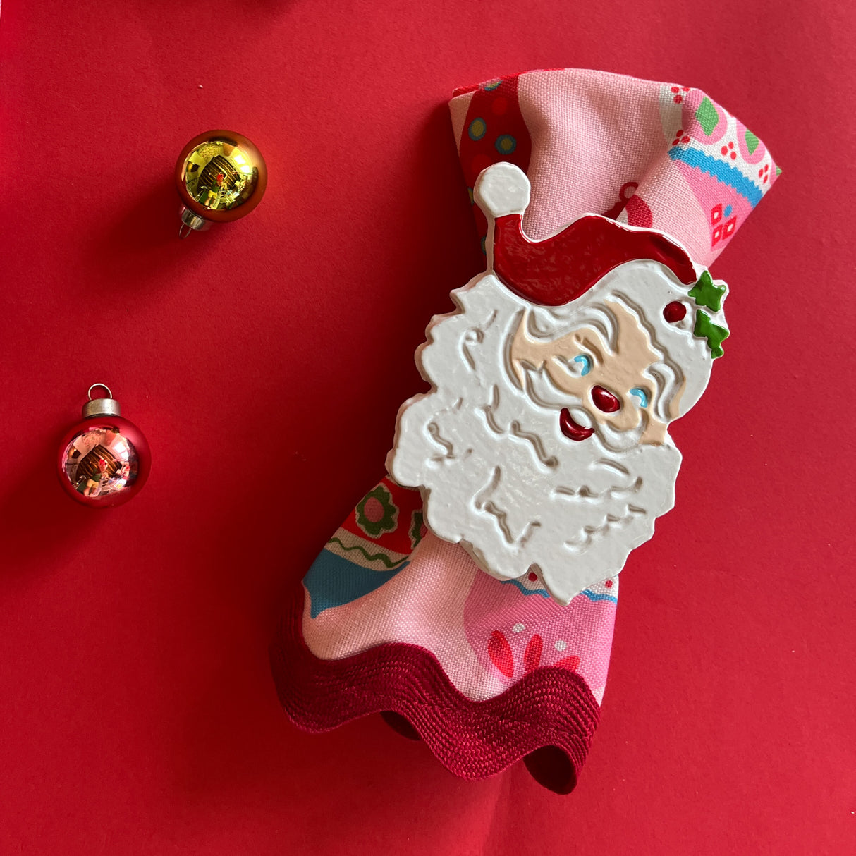 madcap cottage hand-painted metal napkin rings featuring a Jolly Santa design.