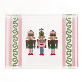 Three Nutcrackers on white background bordered with pink, blue, and green acrylic trays in large size.